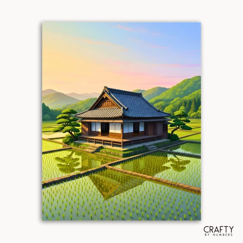 A traditional house surrounded by green rice fields and mountains, shown as a paint by numbers canvas.