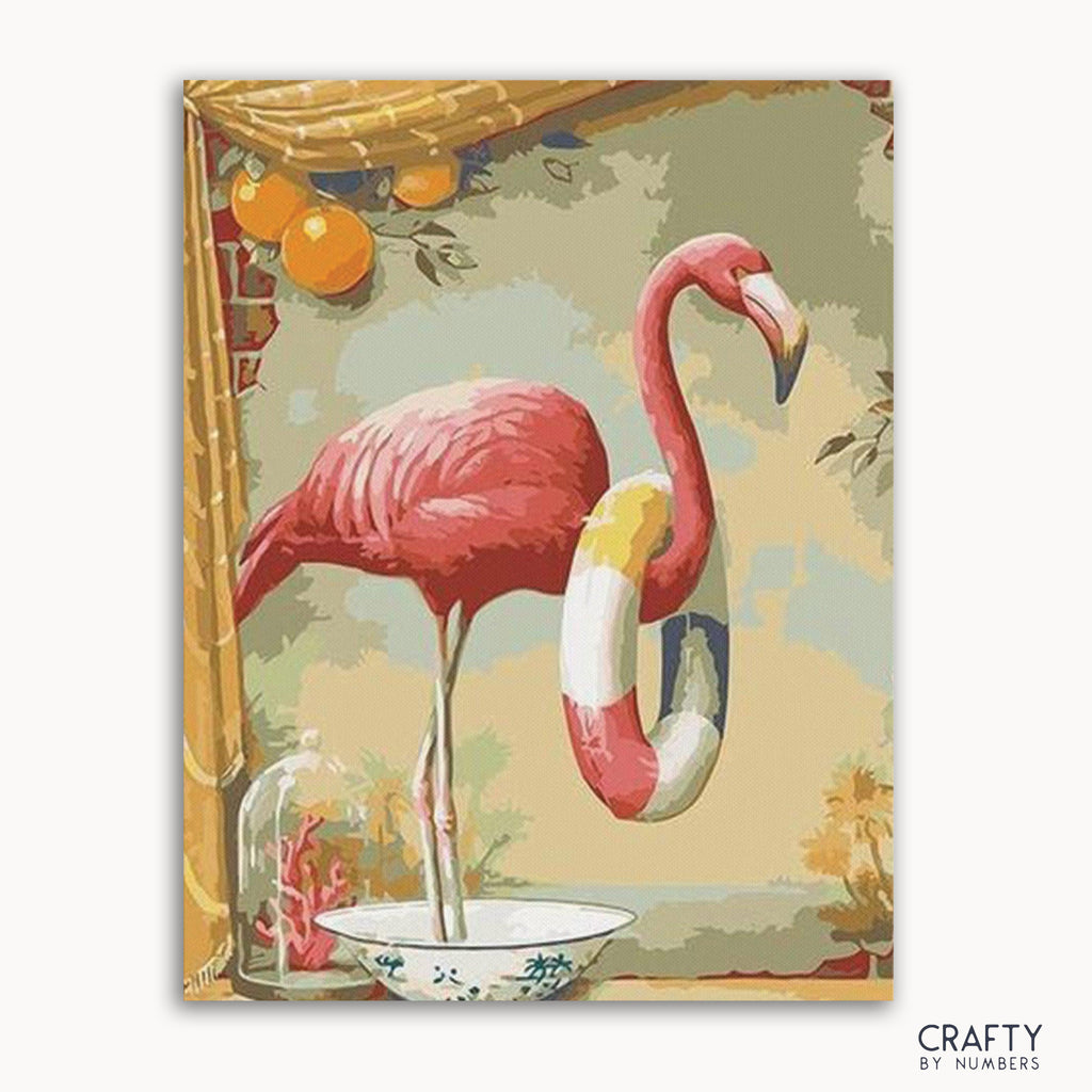 A paint-by-numbers kit image featuring a pink flamingo with a white and yellow umbrella standing on a bowl, with a background that includes green foliage and a bamboo-like structure.