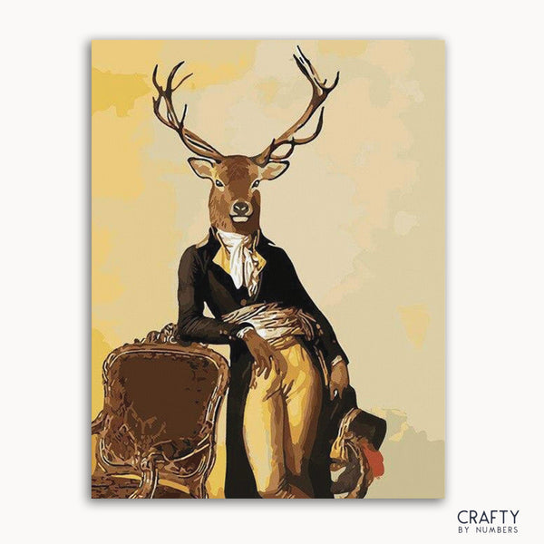 A paint-by-numbers kit depicting a stylized deer character dressed in a suit, seated on a chair against a yellow background.