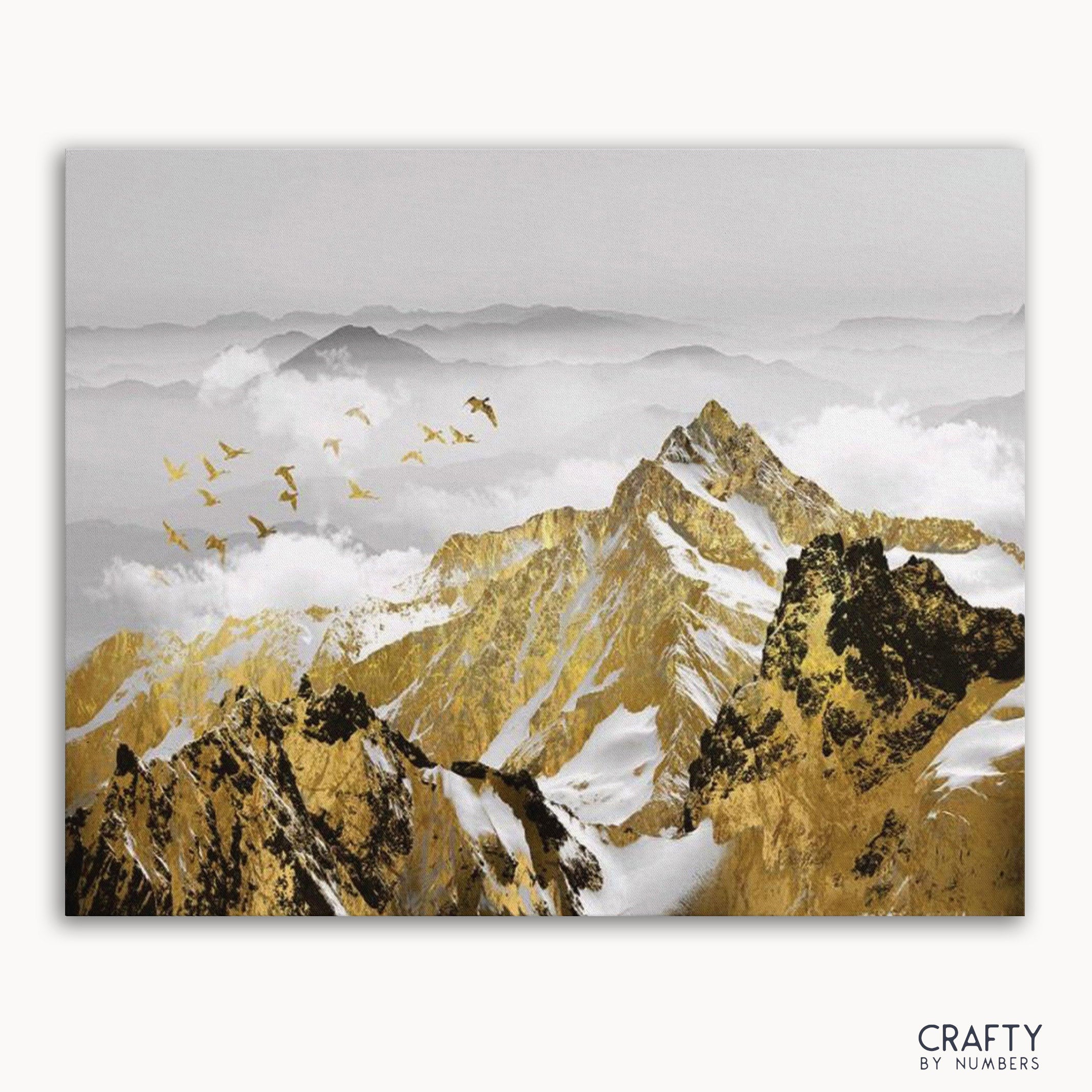 A paint by numbers kit depicting a golden mountains landscape with birds in flight, without a frame.