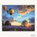 A paint-by-numbers kit image featuring a landscape with hot air balloons in the sky at sunset.