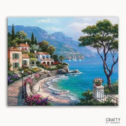 Scenic coastal view with houses and a tree, featuring the brand 'Crafty by Nikules'.