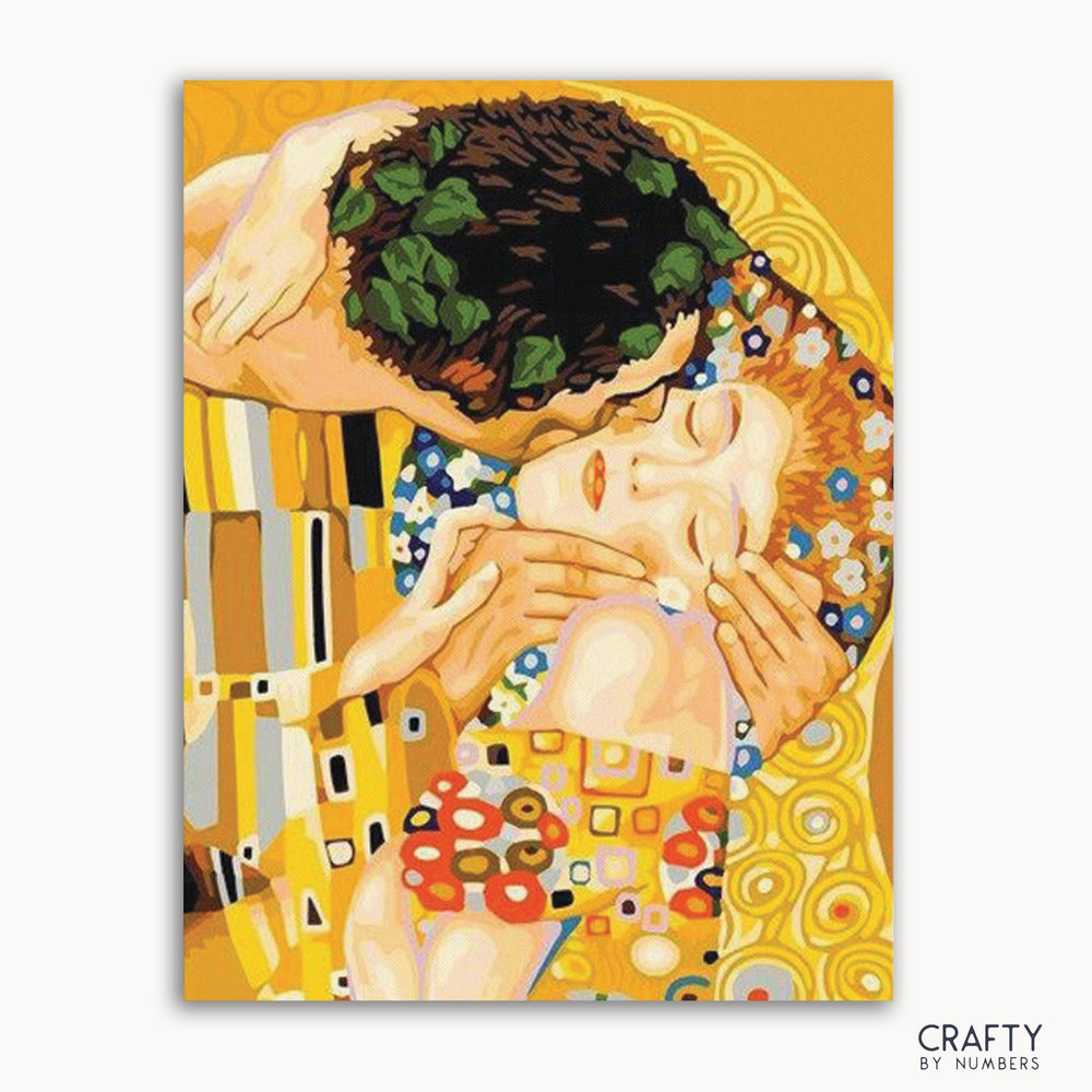 A paint-by-numbers kit featuring the 'Kiss' artwork by Gustav Klimt, with numbered sections indicating where to apply paint.