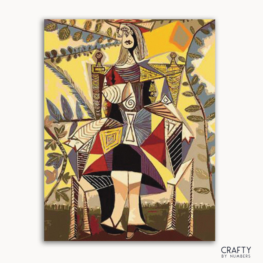 A paint by numbers kit featuring Pablo Picasso's artwork 'Kobieta Siedzę W Ogrodzie' with a depiction of a seated woman in a garden.