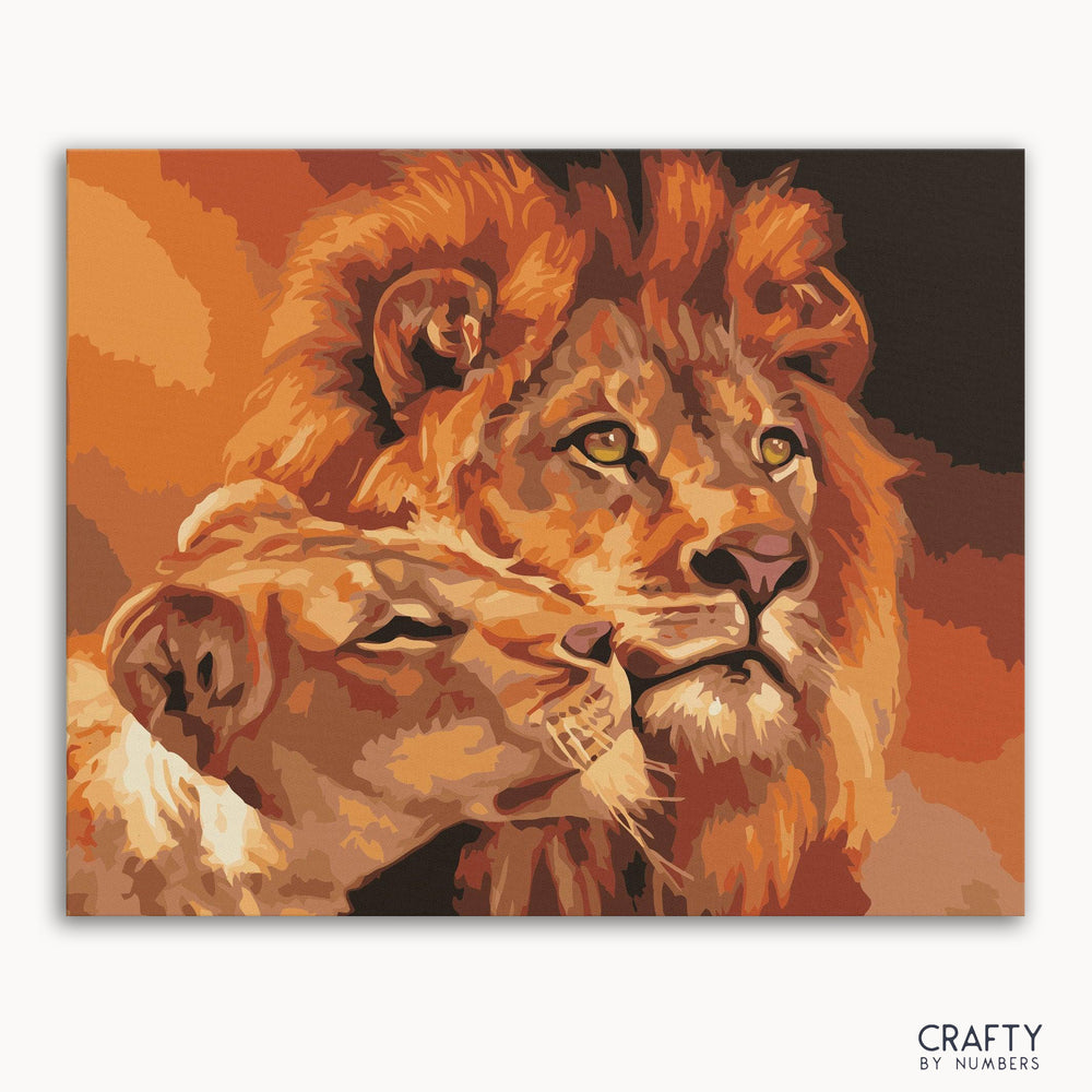 A paint-by-numbers kit image featuring a artistic depiction of a lion and lioness with a warm color palette.