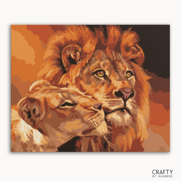 A paint-by-numbers kit image featuring a artistic depiction of a lion and lioness with a warm color palette.