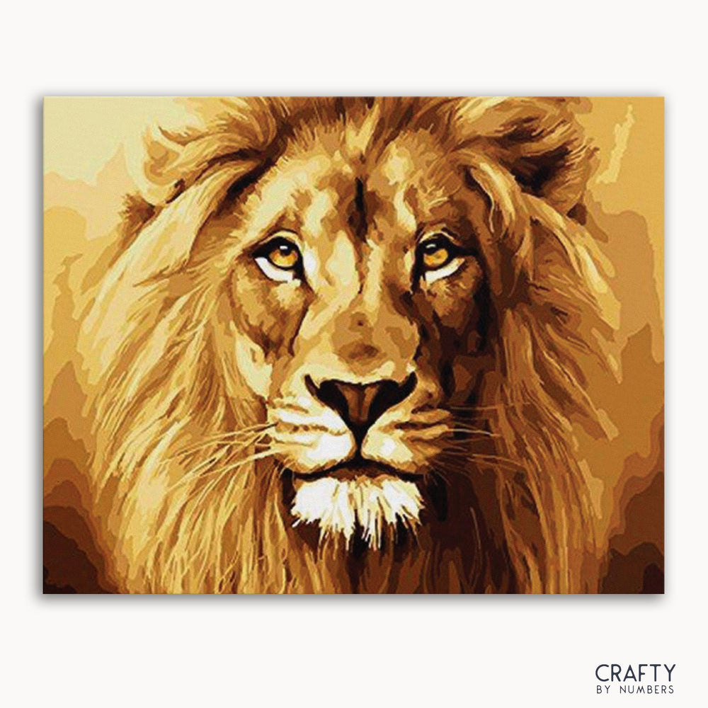 A paint by numbers kit depicting a lion's face with warm brown and gold colors.
