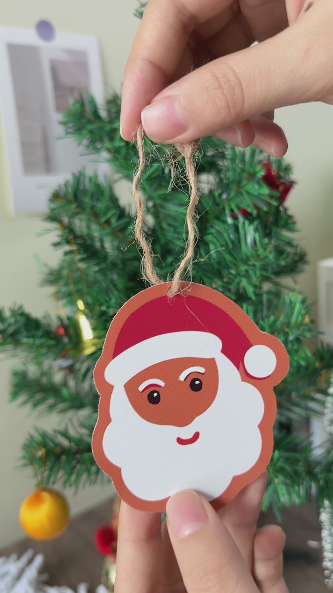 Decorative Christmas tree ornaments featuring Santa Claus and festive sweets.