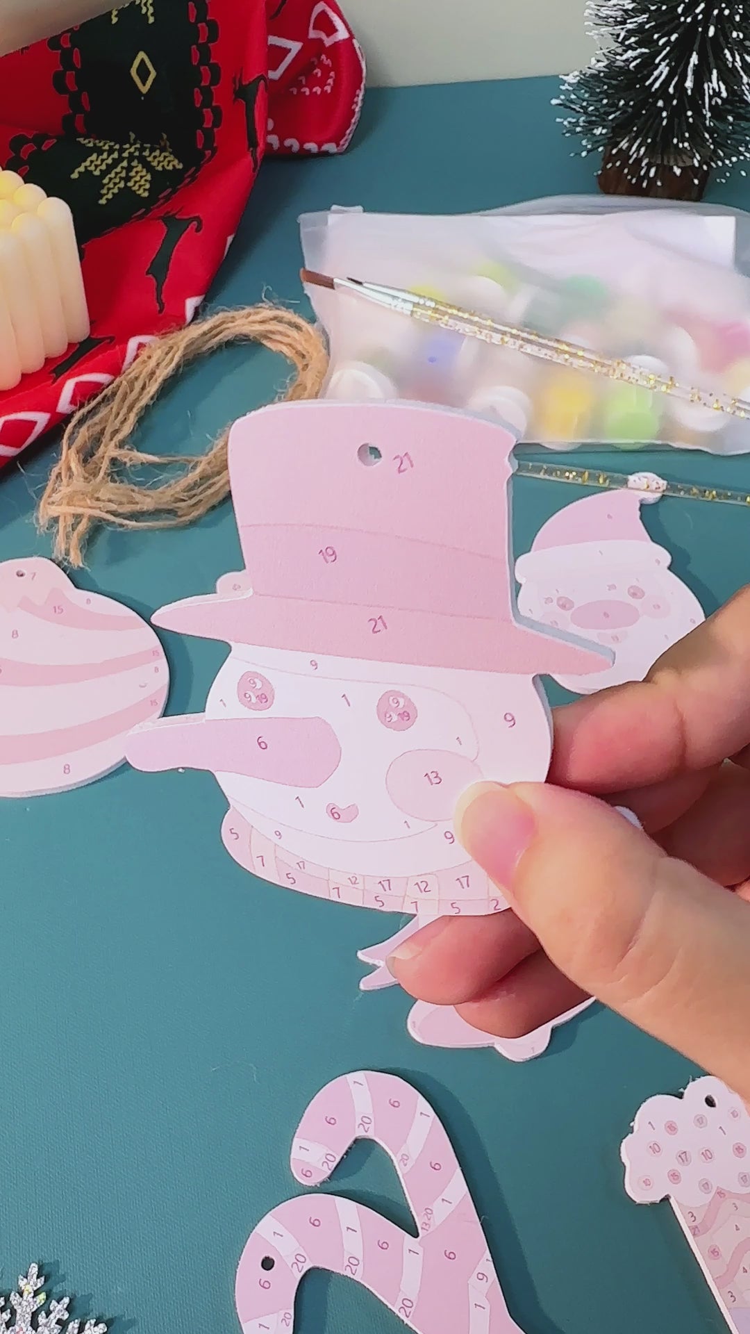 Load video: Hand-painted candy cane Christmas ornaments with sparkly details, perfect for holiday décor.