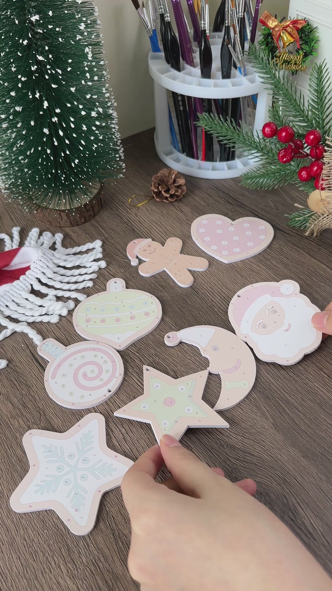 Close-up of Santa-themed holiday ornaments with candy and sweet designs.