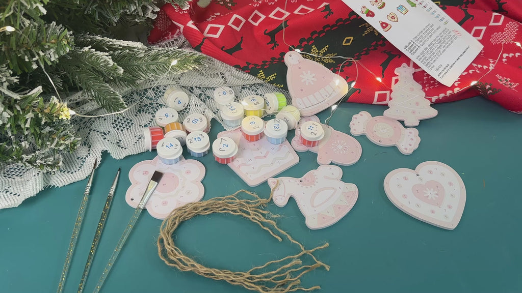 Christmas ornament-making workshop with colorful ornaments, ribbons, and holiday decorations on a wooden table in a warm, festive setting.