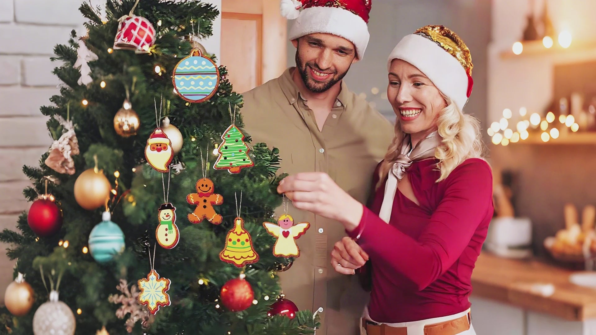 Colorful Christmas ornaments shaped like cookies, decorated with icing and sprinkles, hanging on a festive tree.