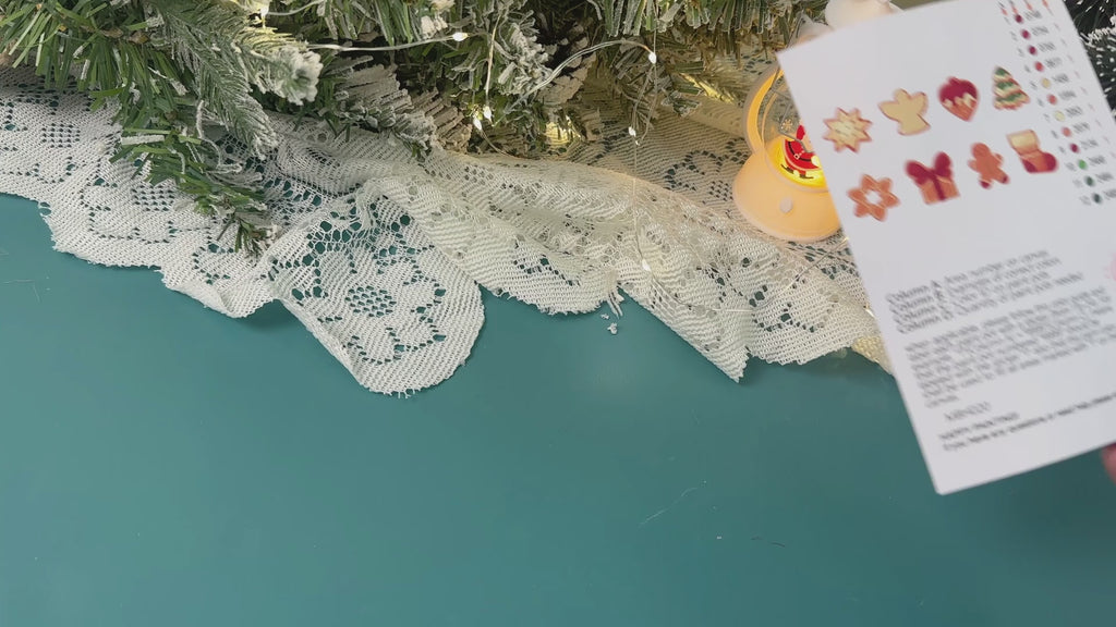 Handmade Christmas ornaments shaped like festive cookies, labeled ‘Baked with Joy.’