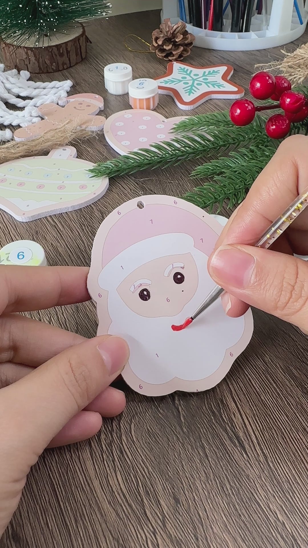 Load video: Colorful Christmas ornaments shaped like Santa’s treats, hanging on a festive tree.
