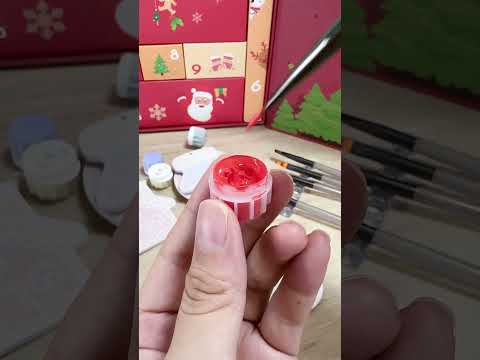 Santa Claus holding a gift, part of the Advent craft by numbers painting.