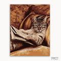 A paint-by-numbers kit image featuring a cat with eyeglasses sitting on a chair, holding a book.
