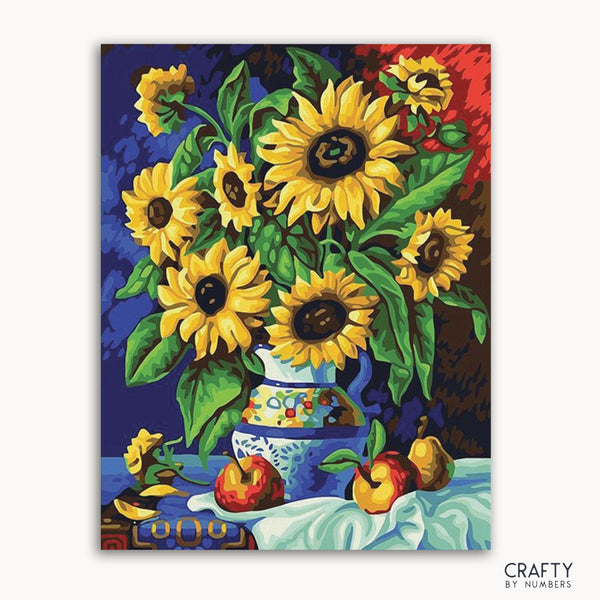 A paint-by-numbers kit image featuring a still life scene with sunflowers in a blue vase, accompanied by peaches on a tablecloth.