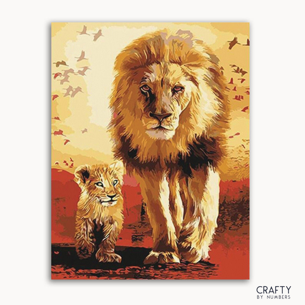 A paint-by-numbers kit depicting a lion and a lion cub with a warm color background and flying birds.