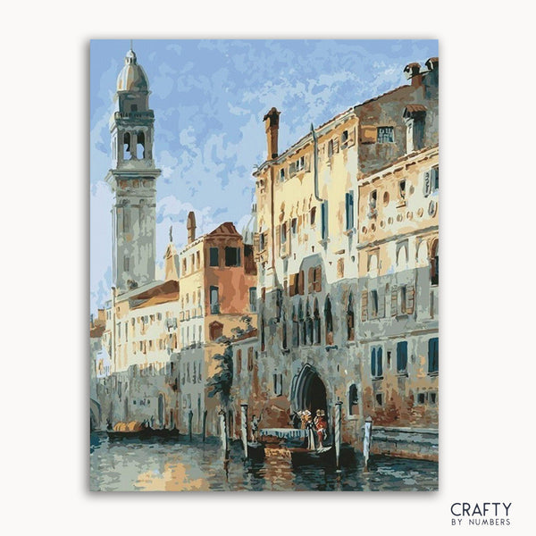 A paint-by-numbers kit depicting a waterside scene in Venice with buildings and a clock tower in the background.
