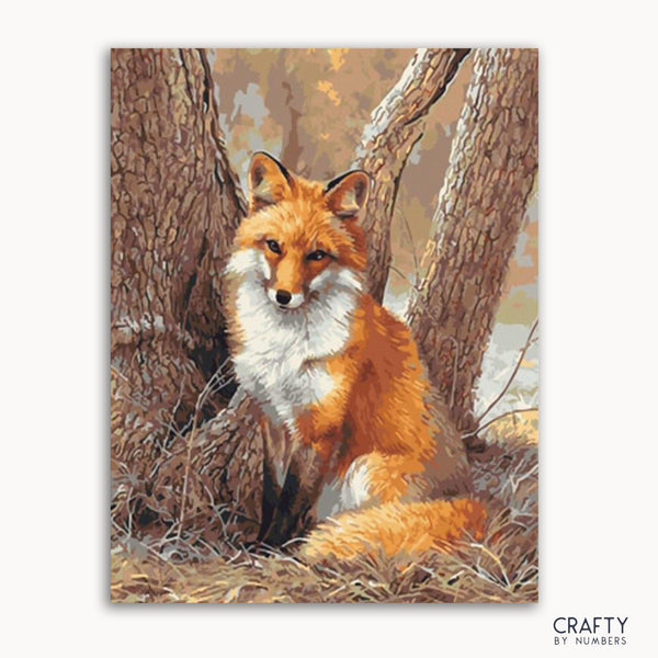 A paint-by-numbers kit image featuring a artistic representation of a red fox sitting near trees.